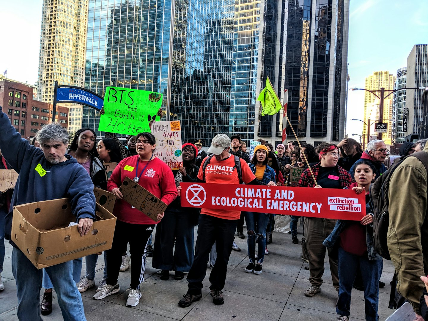 Environmental activists hold signs and banners during a street protest.